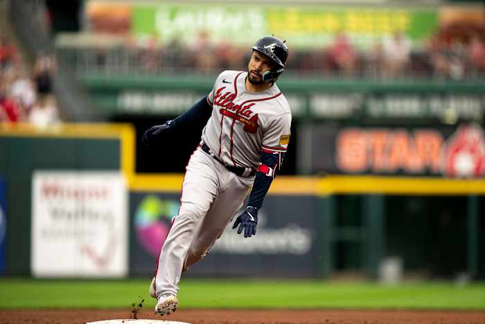 Atlanta Braves catcher Travis d'Arnaud (16) looks at the Atlanta Braves dugout as he rounds third base after hitting a 3-run home run in the first inning of the MLB baseball game between the Cincinnati Reds and the Atlanta Braves at Great American Ball Park in Cincinnati on Friday, June 23, 2023.